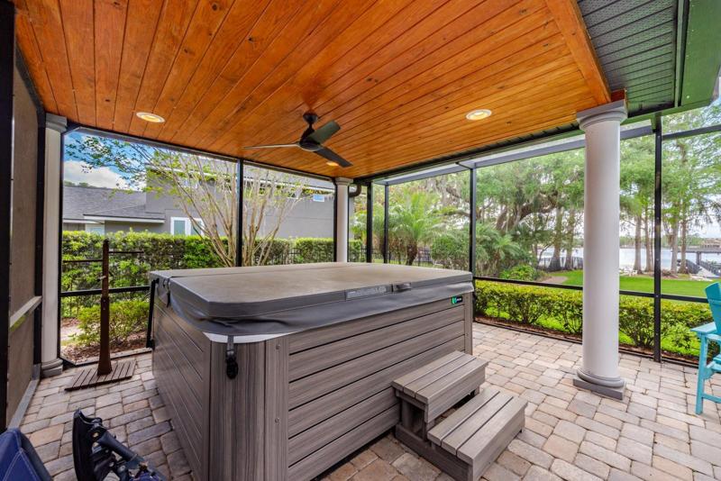 The patio extends under a beautiful wood slat ceiling!