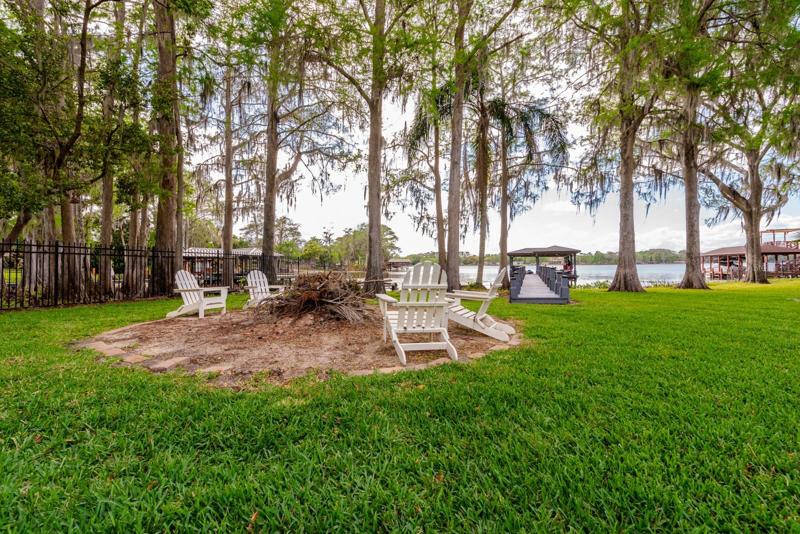 The lush green space is expansive and provides views of Bear Gully Lake as well as a backdrop for your dock and boat house and the perfect place to sit around the fire pit and watch the sun go down!