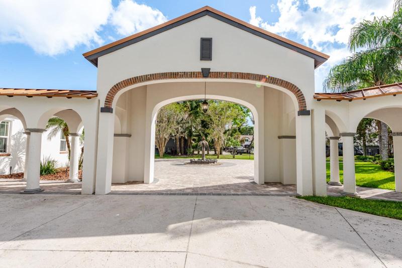 An arched entrance adds grand style and  takes you to your garages!