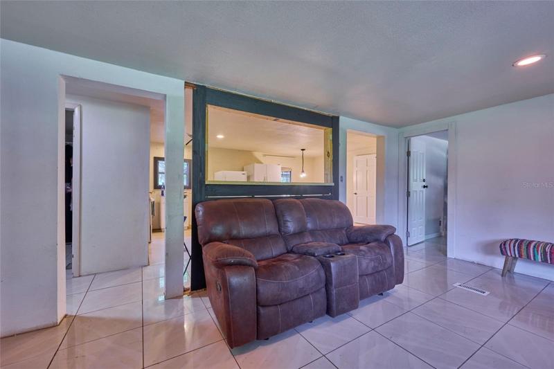 Living room offers access to the guest hall, master bed, and kitchen/dining area