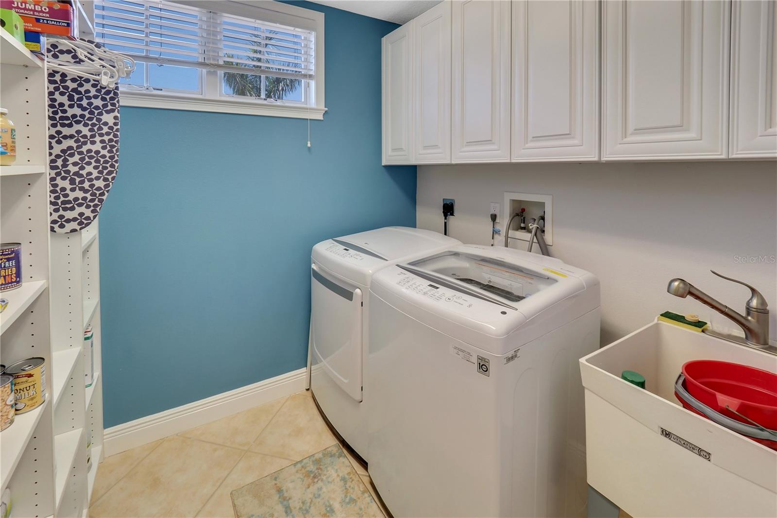 Laundry room with sink and lots of cabinets