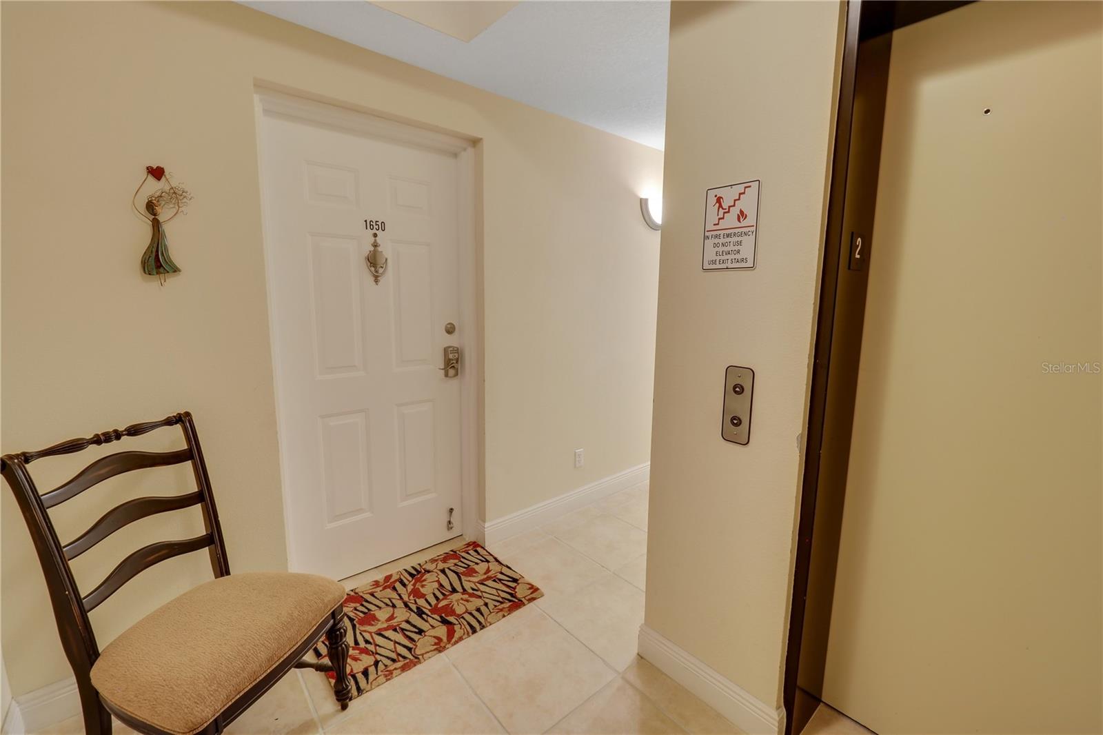 Elevator to right, Door to home to the left