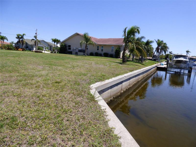 This angle shows the concrete sea wall.  The longer view is your seawall.  The shorter angled wall (foreground) is the adjacent property owner smaller wall. Tide is lower at the time the photo was taken.