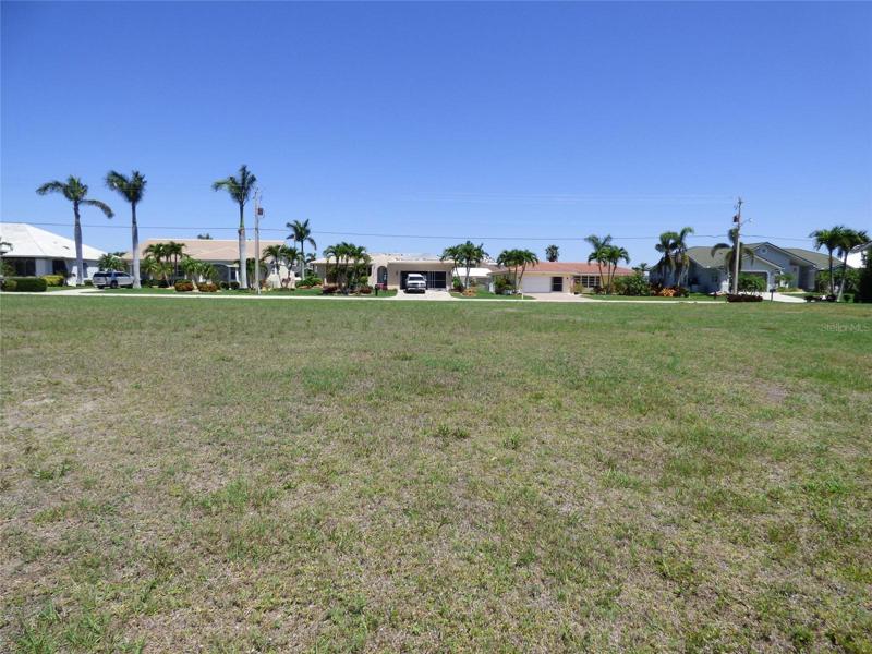 Photo taken from the waterfront looking towards the street.  Homes shown are across the road.