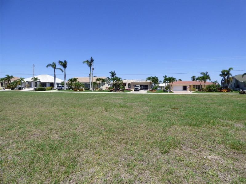Photo taken from the waterfront looking towards the street.  Homes shown are across the road.