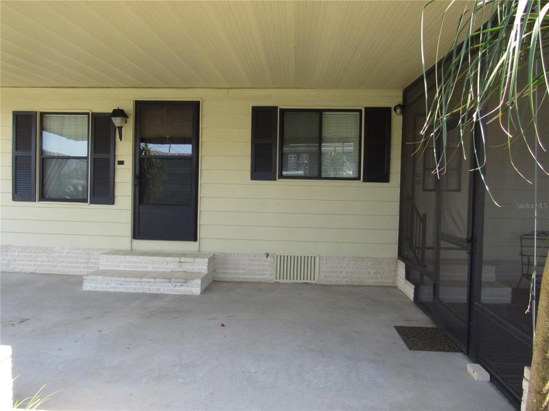 Carport entry & Screen porch.
