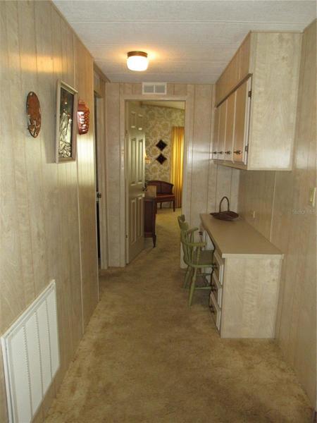 Hallway with built-in desk and storage cabinets.