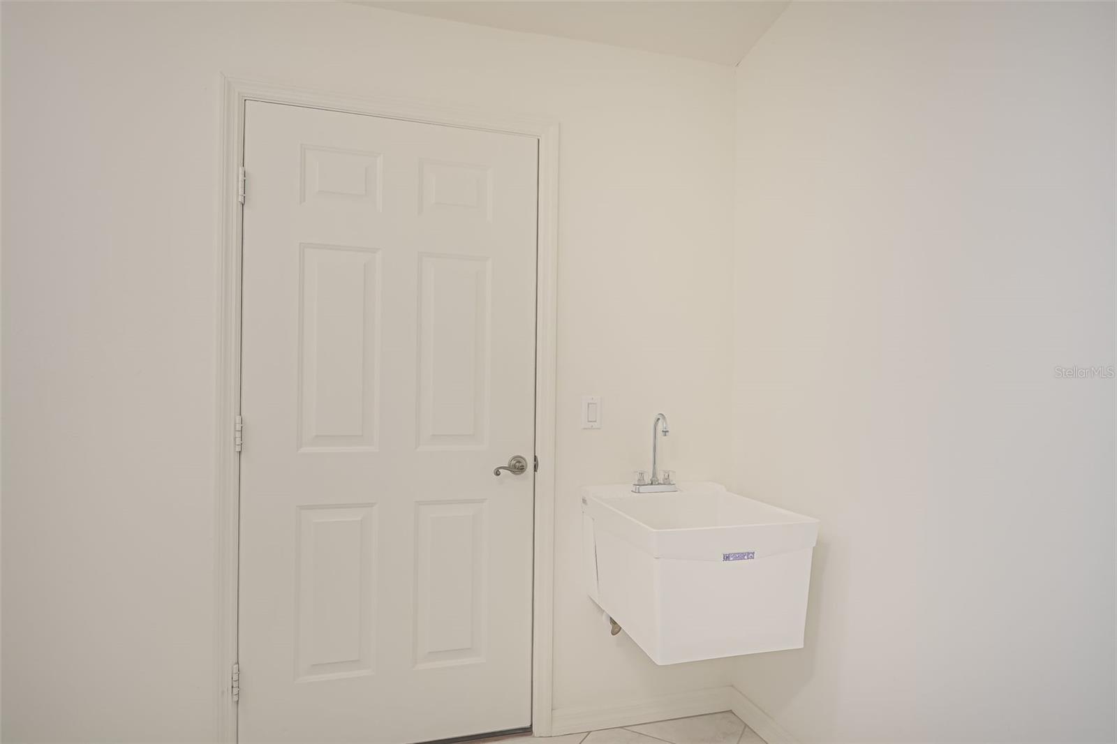 Utility room deep sink and door to 2 car garage.