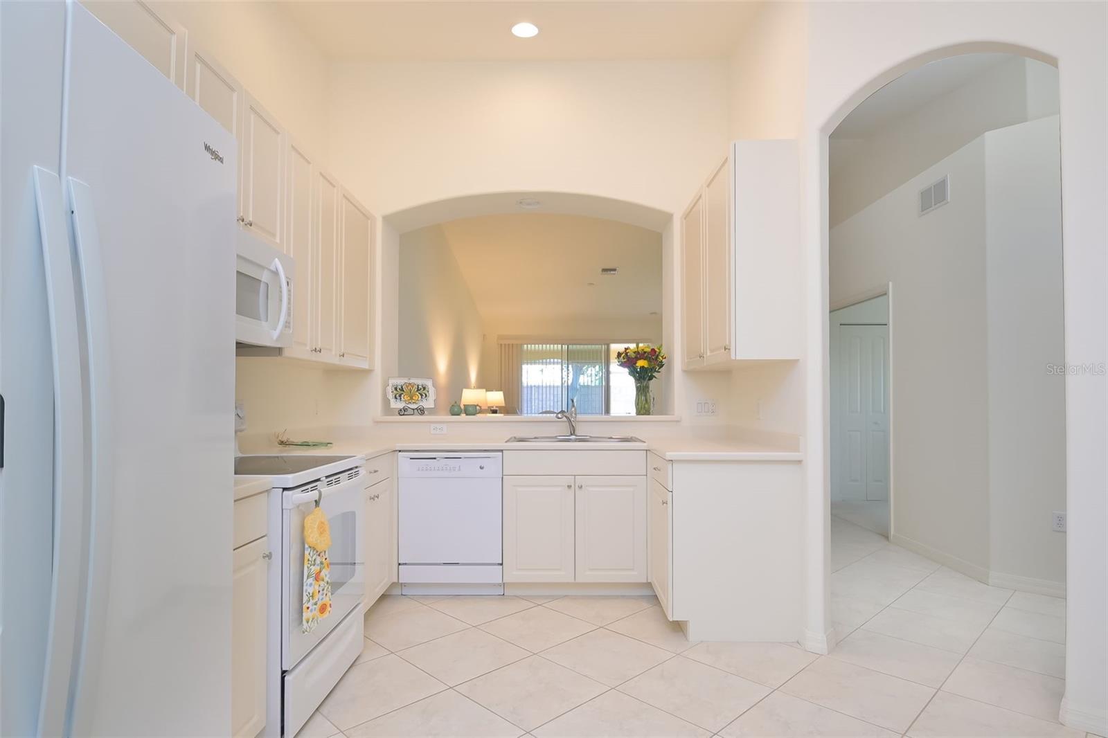Kitchen and pass-through to dining area.