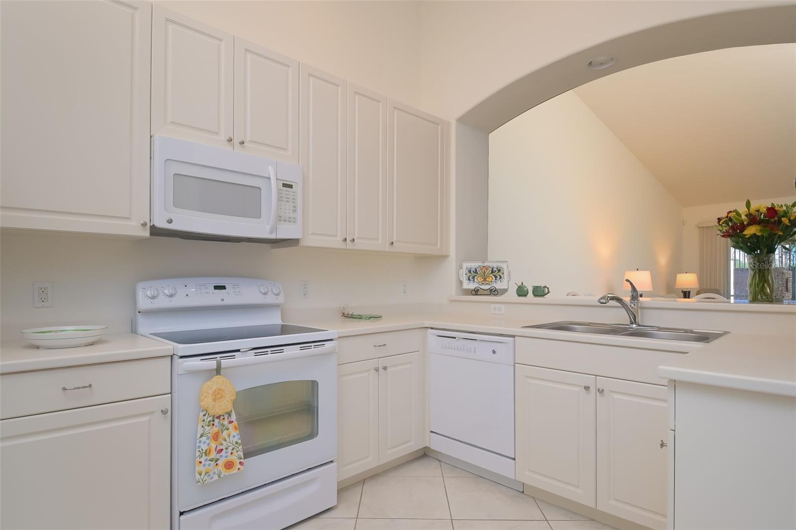 Solid surface counters and pass-through to dining area.