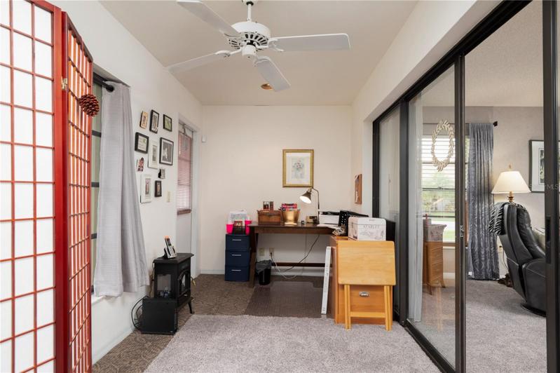 Florida room has sliders and windows