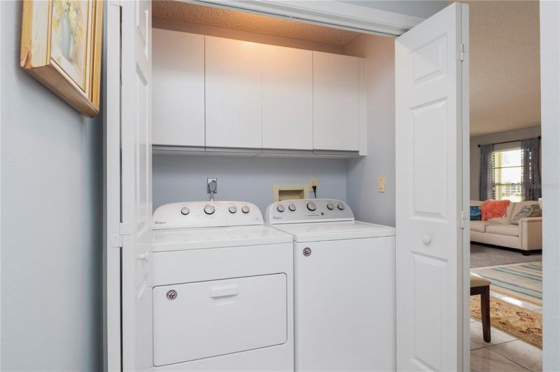 Laundry Closet with cabinets and overhead light