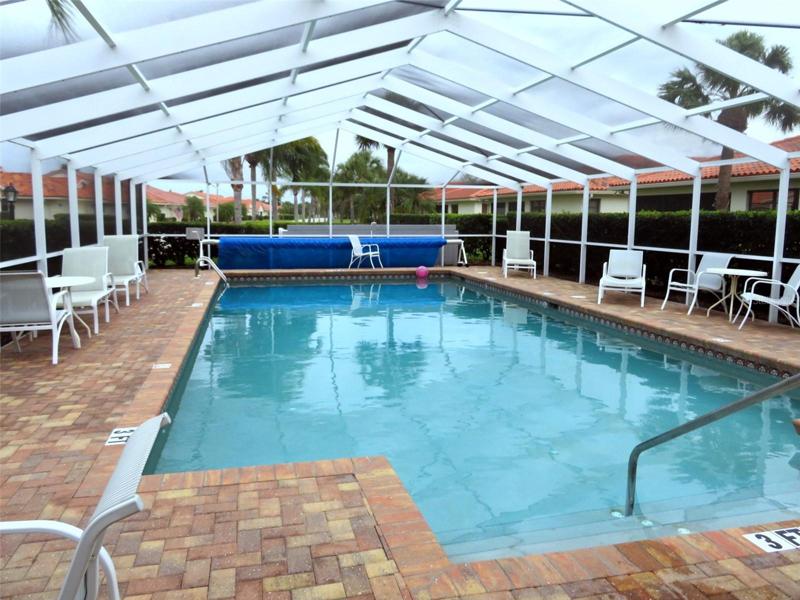 Caged pool with nice paver decking