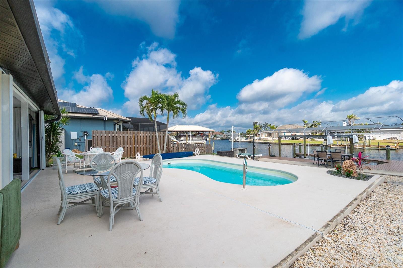 The View from the Lanai, which is surrounded by two walls and the sliding glass door from within the home, however you can slide the shutters and enclose the entire Lanai, stopping the view to the water at night!