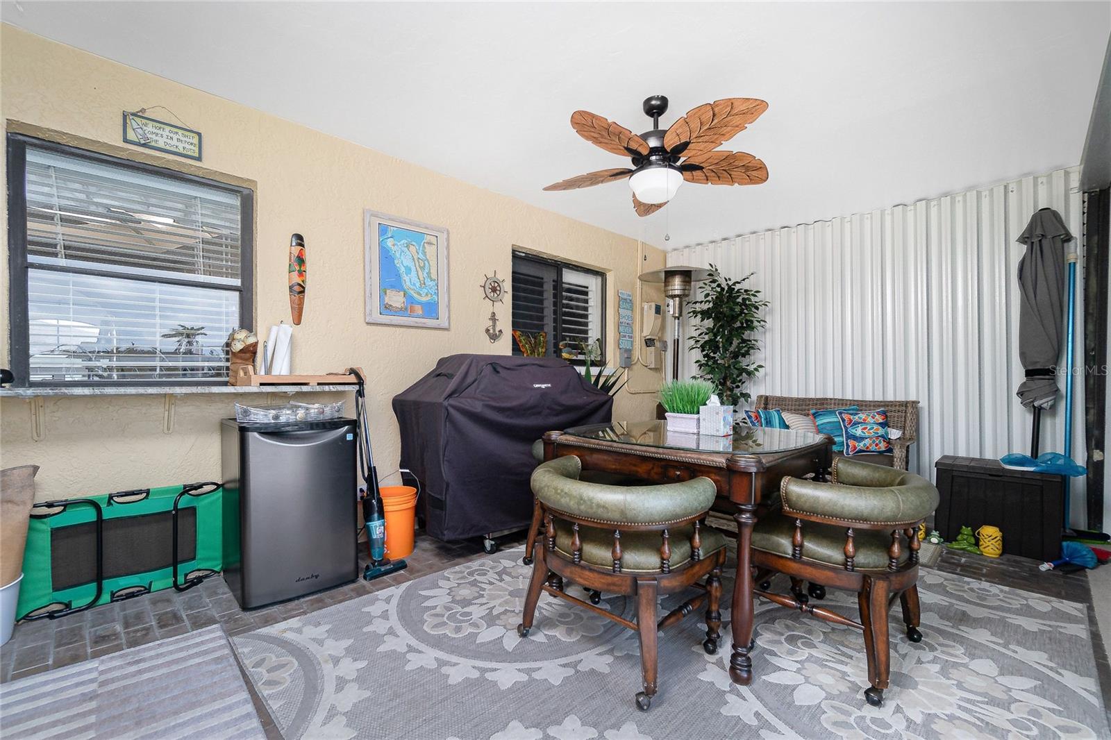 This furniture and grill stay on the lanai, which has a straight view to the pool and Dock