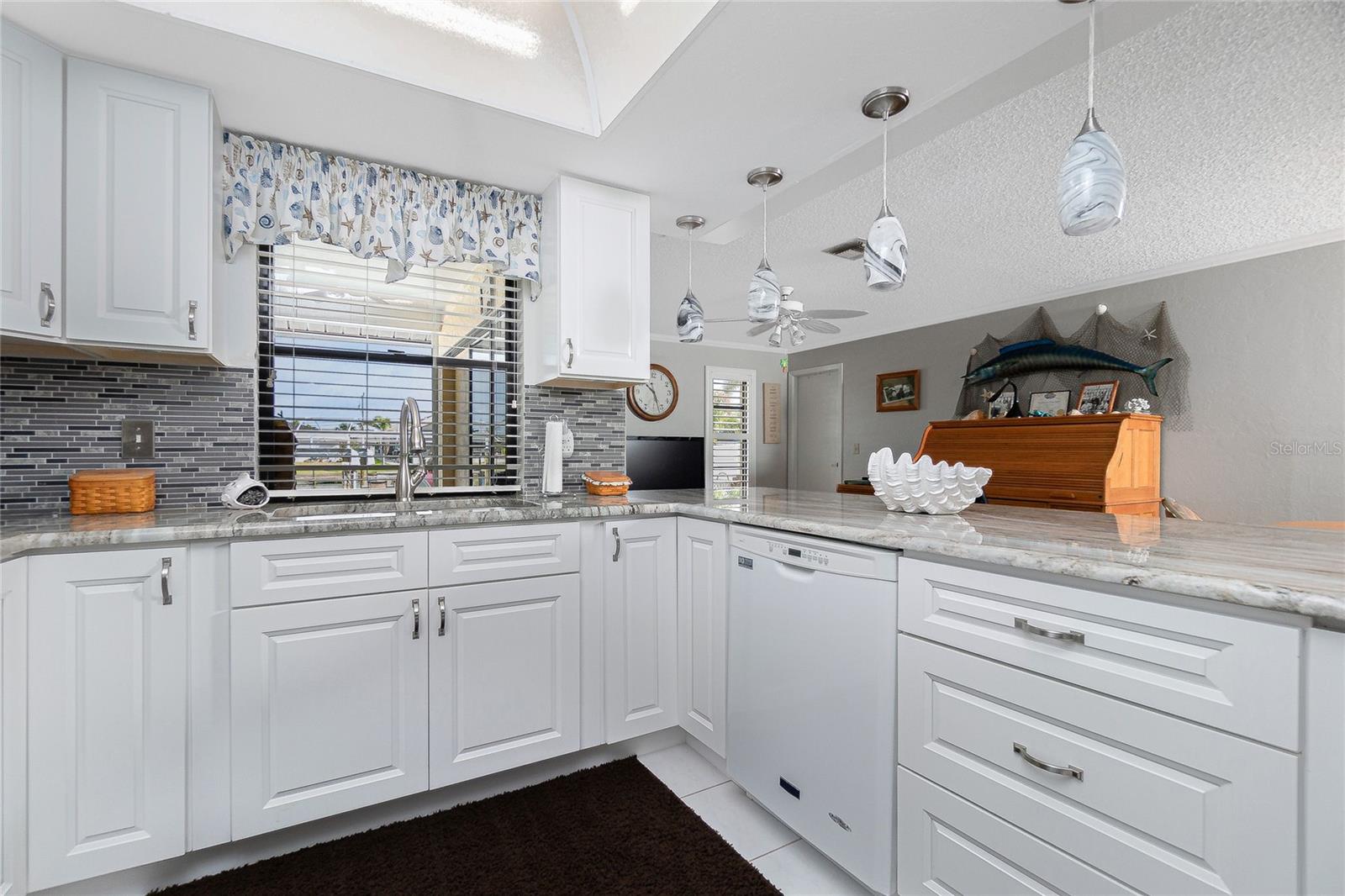 While cooking on your upgraded granite counters, or rinsing of the dishes, your view is on the pool, dock and canal!