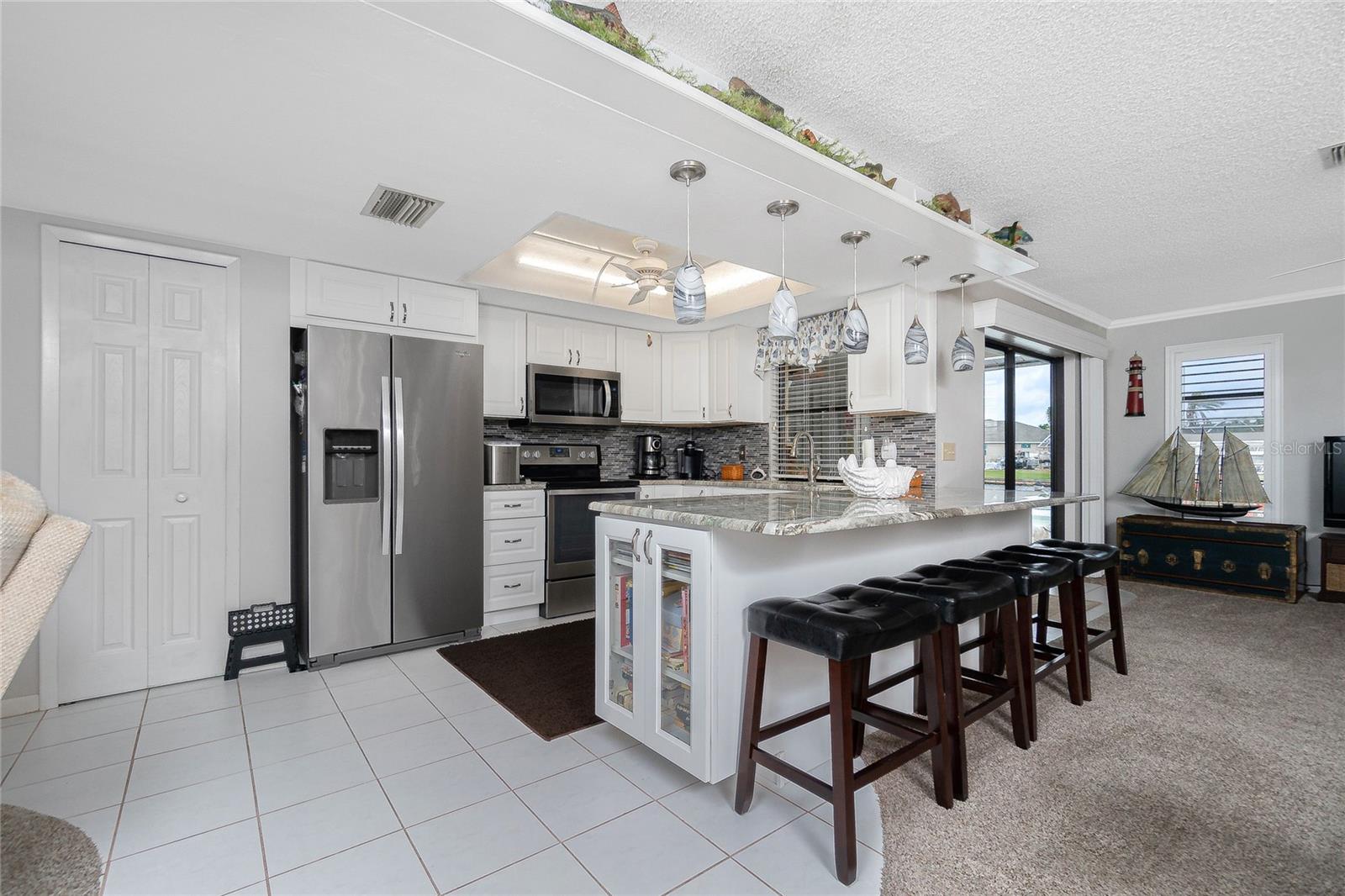 the kitchen has been updated with granite counter tops as well as the breakfast bar