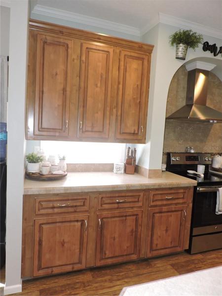 Kitchen conter & cabinet to the right of range.
