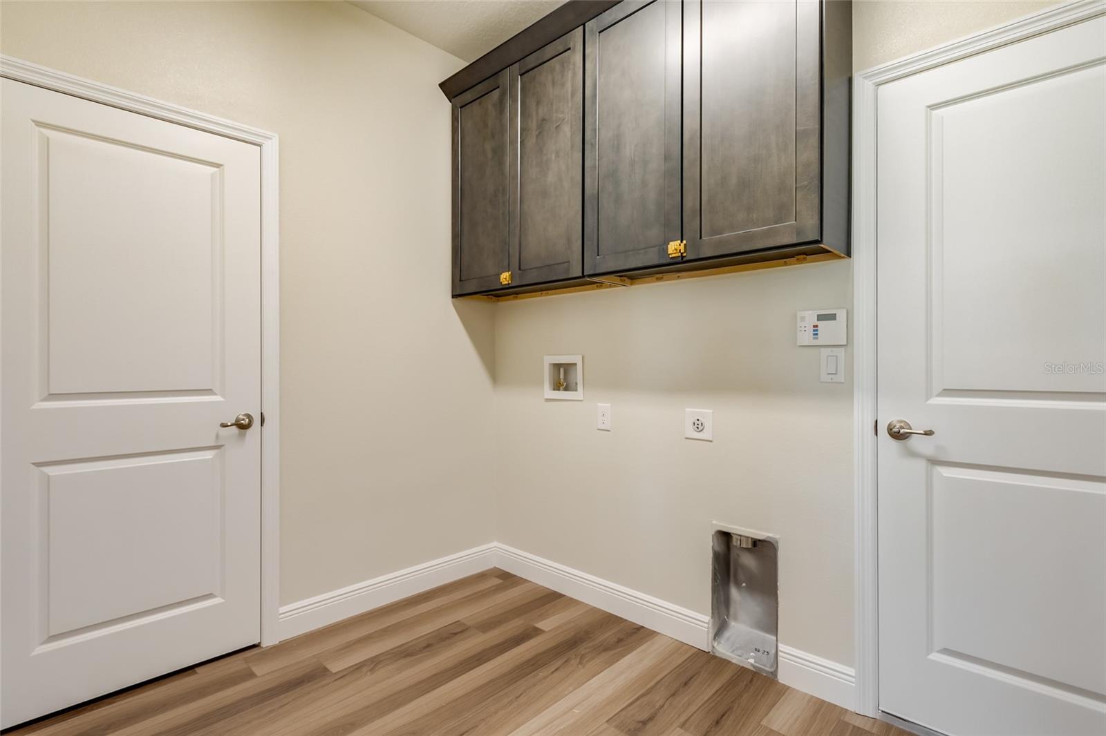 Same floor plan-not the home for sale. Home is under construction so colors and selections may vary. Laundry cabinets are optional