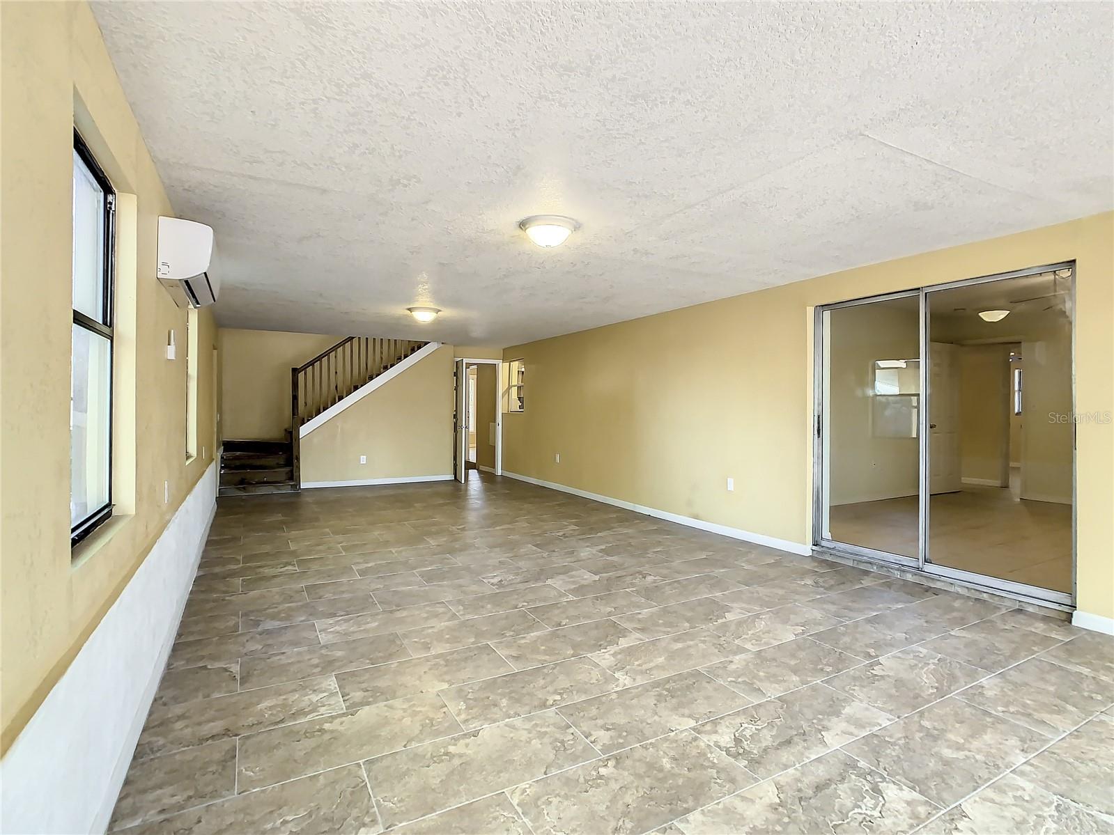 Another view of the Great Room with stairs to the upstairs Bonus Room and Game Room