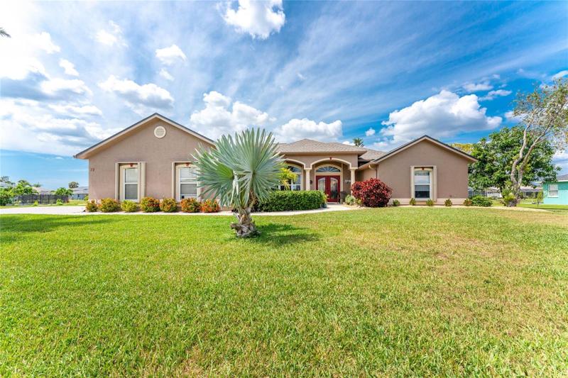 Relaxing comes naturally in this gracious home nestled on a beautifully manicured double estate lot within the highly desired community of Rotonda West.