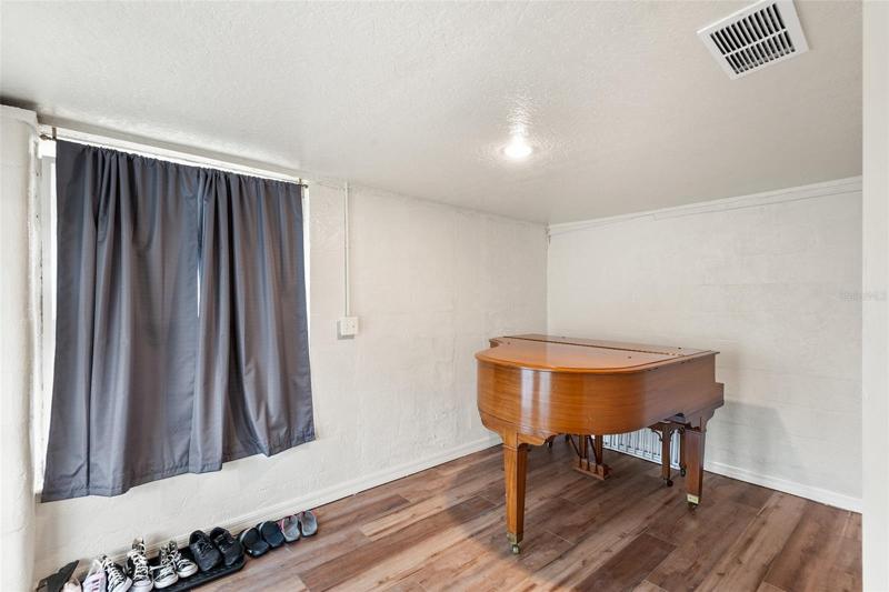 Bonus Room setup with piano