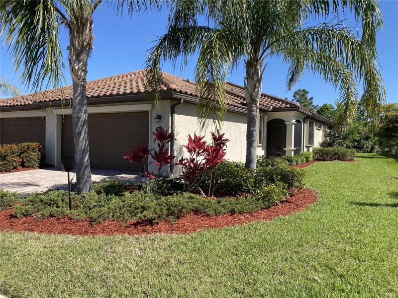 Front of home with mature landscaping providing great curb appeal