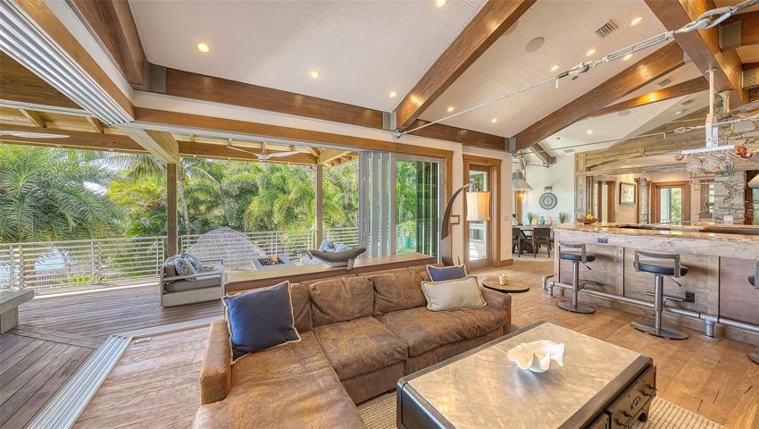 Walls of windows open the main living area to the expansive terraces & outdoor kitchen