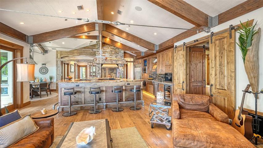 A custom "spalted  free edge walnut" breakfast bar connects the large kitchen to the great room