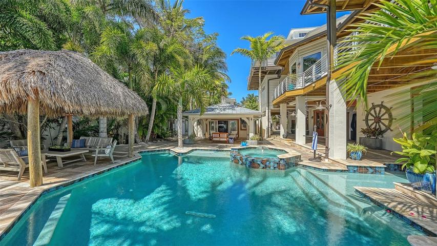 The "Pool House" has a fun covered patio for catching a baseball game while sipping on a cool beverage, or relax in one of the many palapas to take in the views!