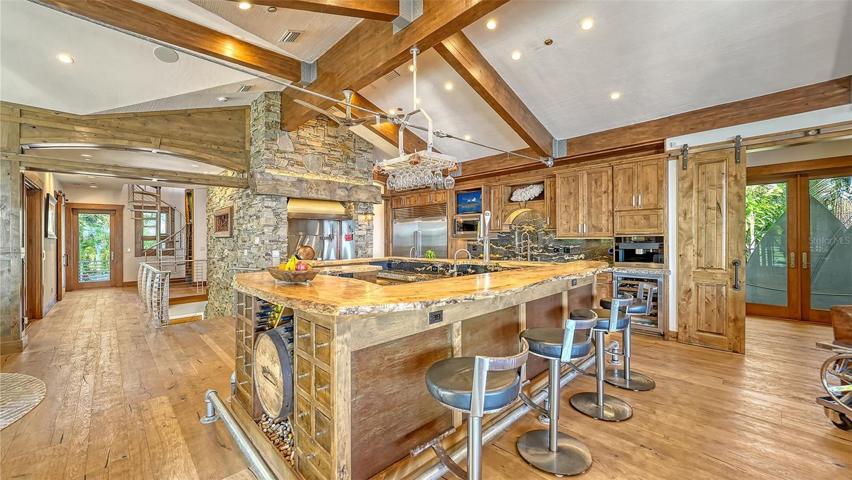 Custom barn doors separate the "owners Suite" from the main hub of the home