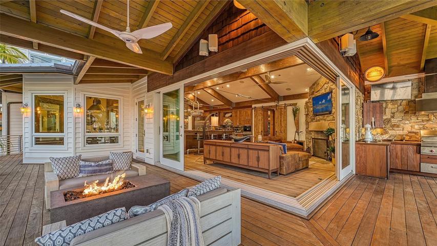 The outdoor space is enhanced by  the outdoor kitchen w/ another beer "kegerator" with many seating areas