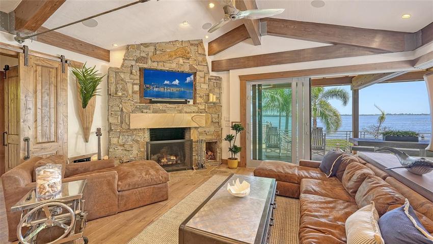 The custom architectural blend of metal, wood & stone draws your eye to those amazing water views!
