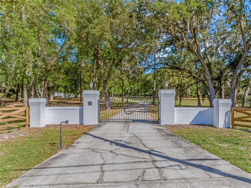Gated entry with mature Oak trees to lead you home!