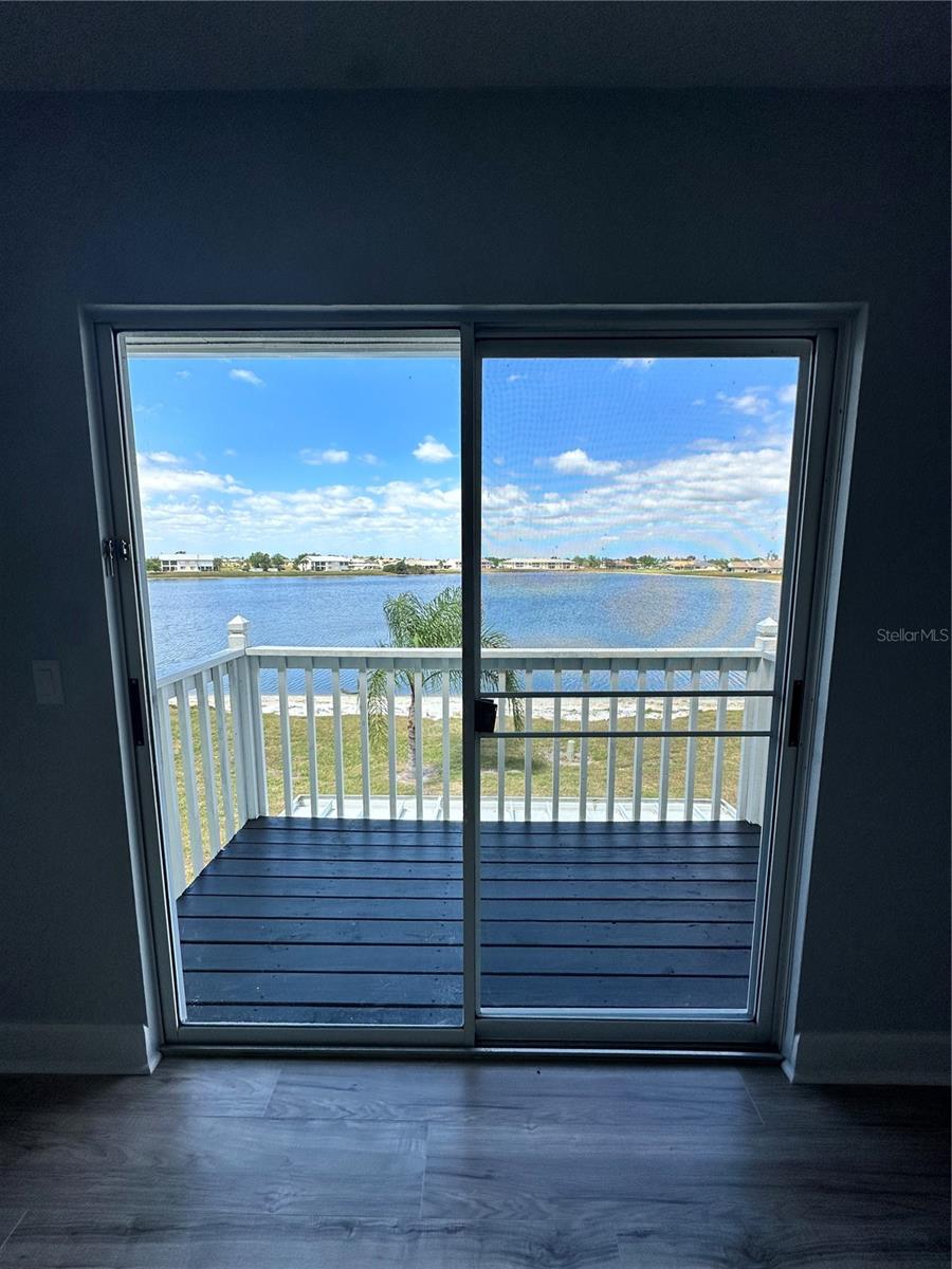 Lake view through master bedroom sliding doors