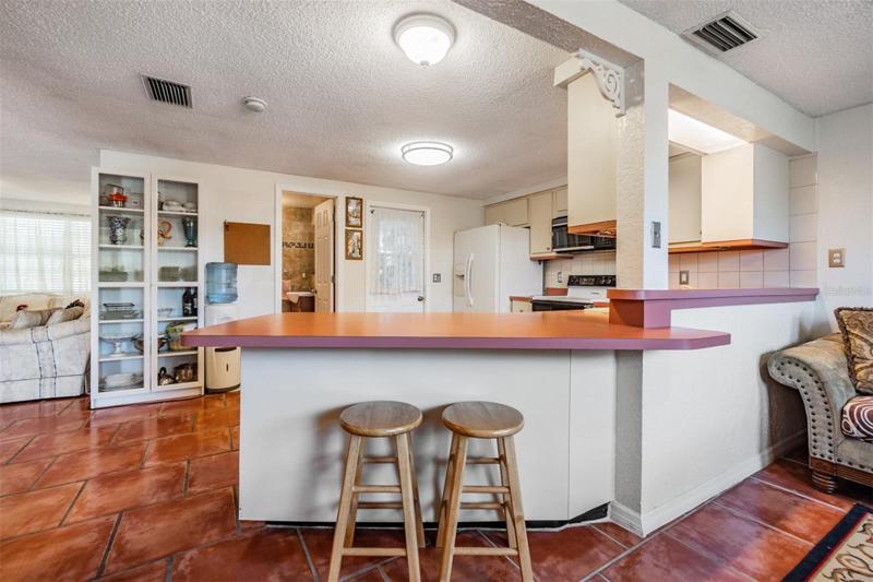 Open Kitchen with bar area and family room to the right.
