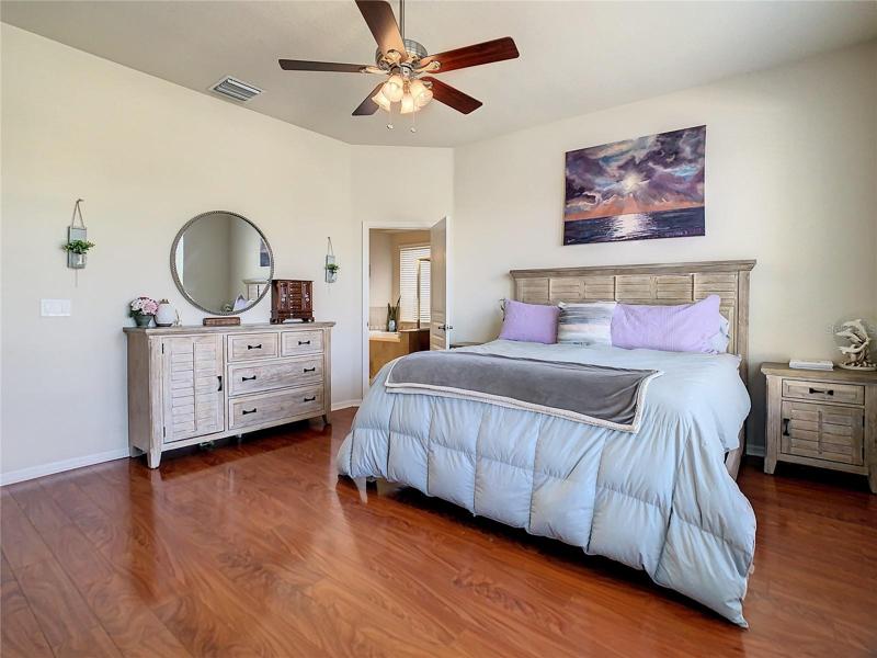 Master bedroom featuring laminate flooring