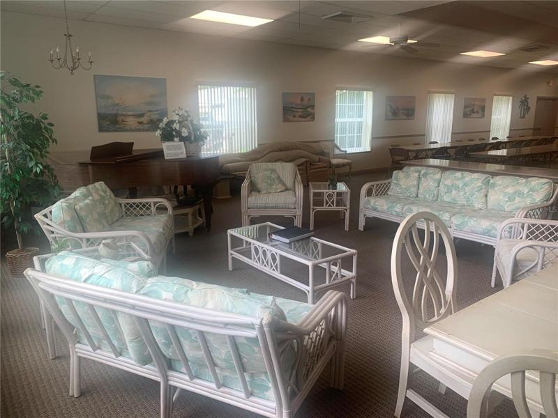 Sitting area near piano in Clubhouse w/puzzles!