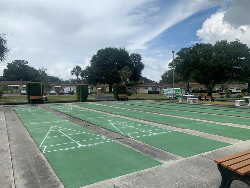 Shuffleboard courts beside pool and clubhouse