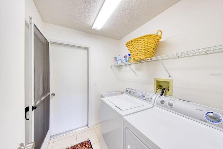 Inside laundry room with utility sink leads to garage~