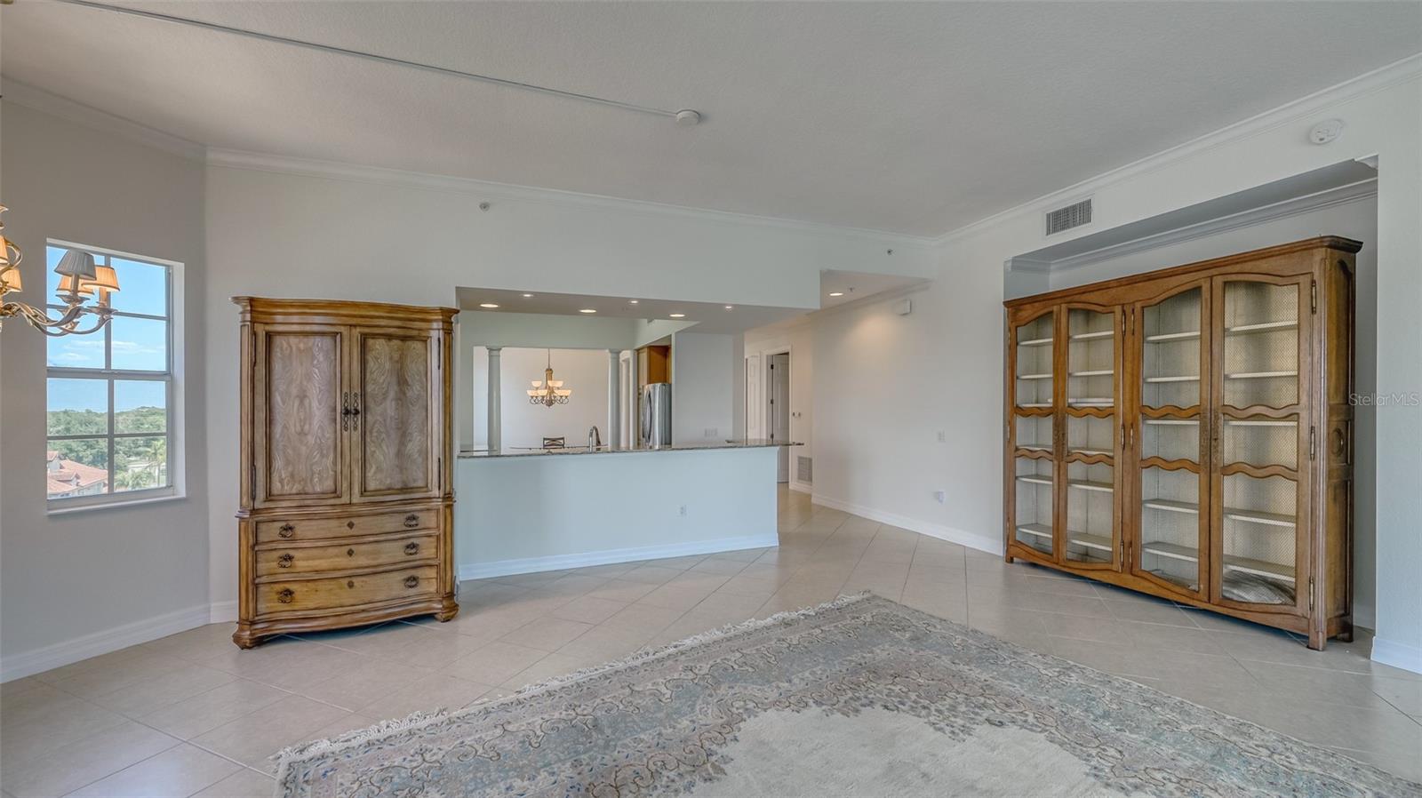Living room toward kitchen and entry hallway