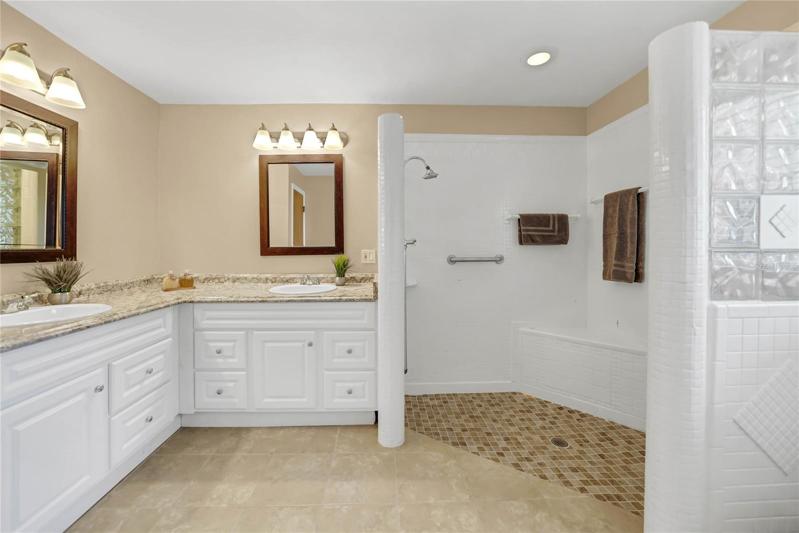 PRIMARY BATHROOM WITH DOUBLE SINKS AND DUAL SHOWER HEADS