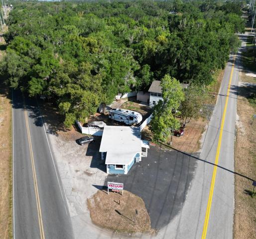 Sits at intersection with Retail building on busy road and home on side street