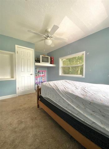 Third bedroom upstairs has built-ins, ceiling fan and a decent size closet. It is the smallest of the bedrooms.