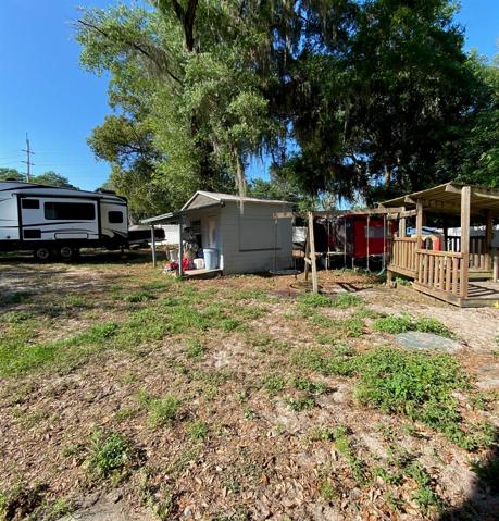 There is a lot going on back here making it tough to see the full size. Camper, RV, Trampoline, Swing-set, Playhouse etc... However it is very roomy with a nice mix of sunshine and shady spots.