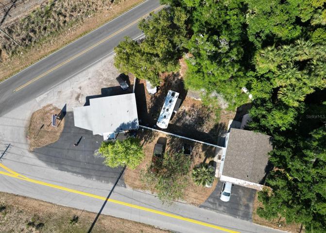 3/2 Home with a commercial building. Large pie shape lot with fenced back yard. Oh, See the NEW ROOFS