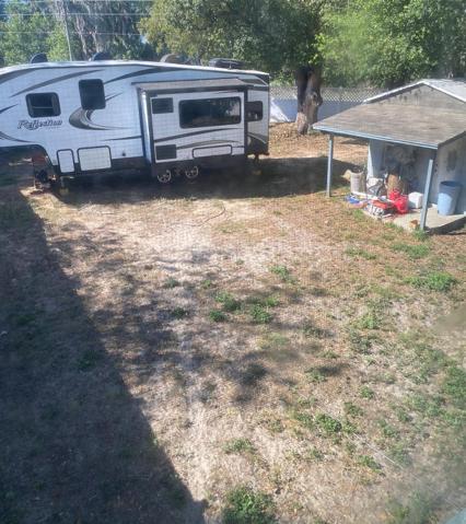 Backyard from upstairs window. The little block building out back also has a newer roof. Yard has Vinyl Privacy fencing