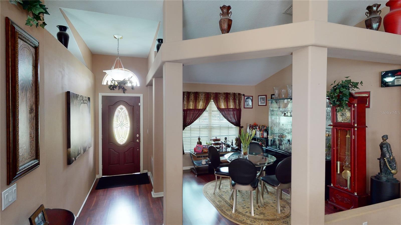 Step into the stunning front foyer, where the grand entrance immediately captures your attention. The door with leaded glass and upper arched transom window creates a timeless and sophisticated aesthetic, while the natural light that floods the space creates a warm and inviting ambiance. This exquisite front foyer is the perfect introduction to the home's tasteful design and attention to detail, making a lasting first impression that is sure to impress.