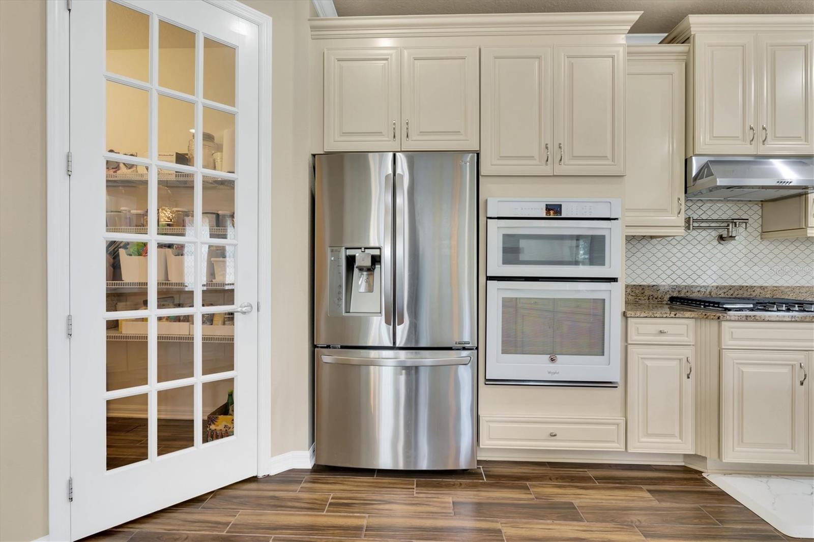 FRENCH DOOR IN KITCHEN LEADING TO LARGE WALK IN PANTRY 