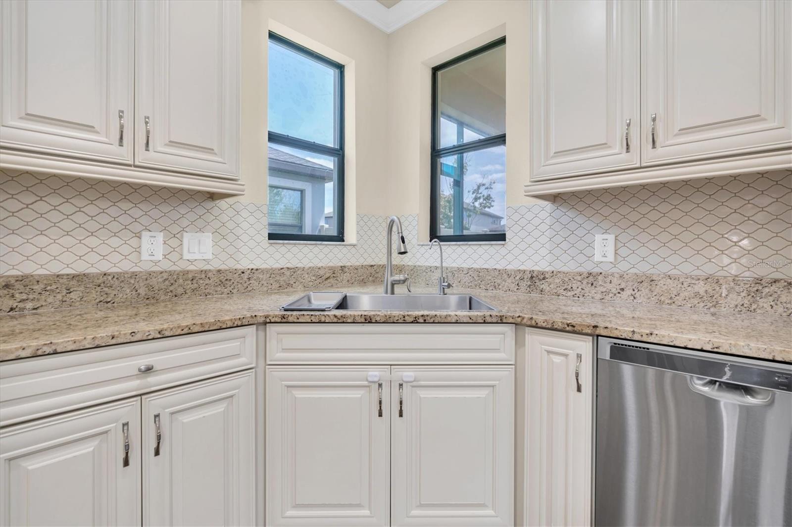 PLENTY OF COUNTER SPACE AND WINDOWS BY SINK